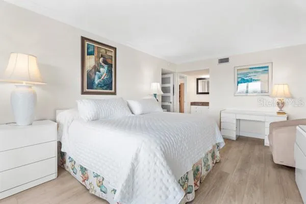 a spacious bedroom with a bed and a large window