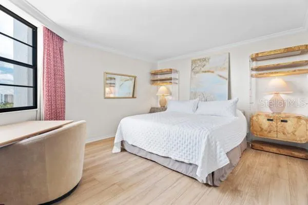 a bedroom with a bed dresser and a window