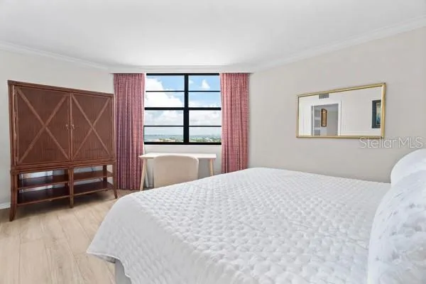 a bedroom with a large bed and a window