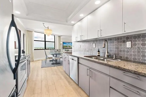 a kitchen with sink cabinets and outdoor view