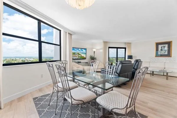 a view of a dining room with furniture a rug and wooden floor