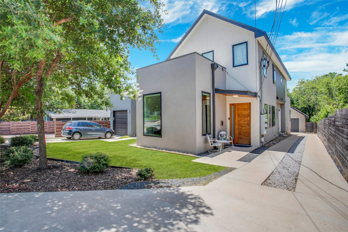5402 Woodrow Avenue, Unit B Austin, TX 78756 - Photo 1 of 36 a front view of a house with a yard and garage