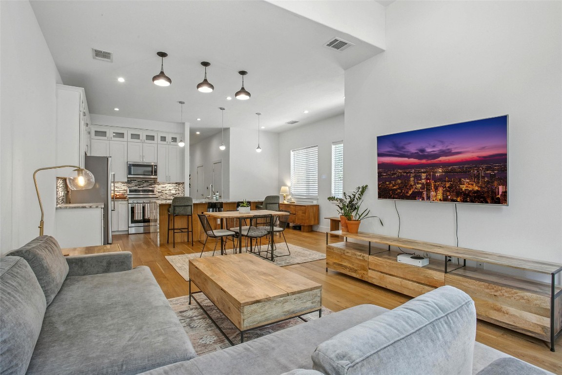 5402 Woodrow Avenue, Unit B Austin, TX 78756 - Photo 11 of 36 a living room with furniture kitchen view and a flat screen tv