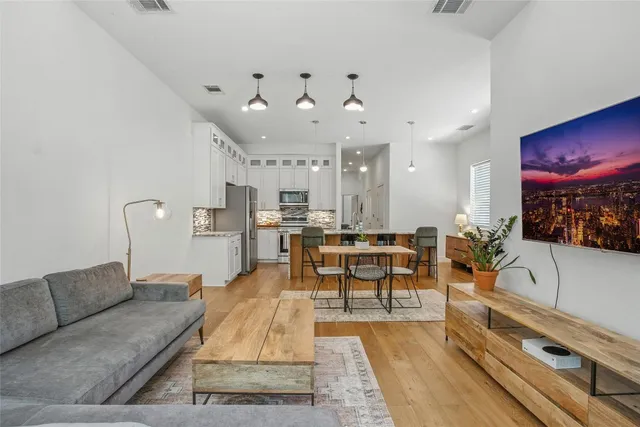 a living room with furniture and kitchen view