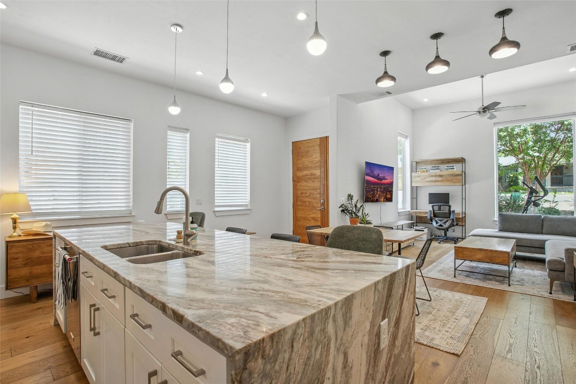 5402 Woodrow Avenue, Unit B Austin, TX 78756 - Photo 36 of 36 a kitchen with stainless steel appliances granite countertop a sink dishwasher and cabinets with wooden floor
