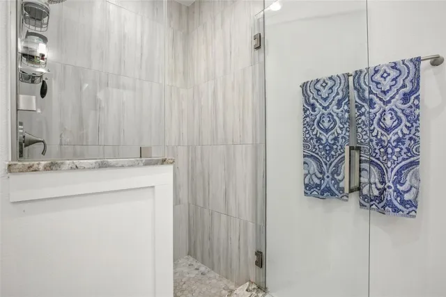 a bathroom with a granite countertop double vanity sink and a mirror