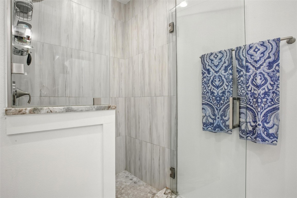 5402 Woodrow Avenue, Unit B Austin, TX 78756 - Photo 25 of 36 a bathroom with a granite countertop sink and a mirror