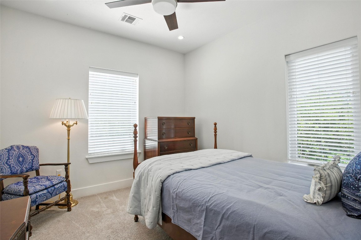 5402 Woodrow Avenue, Unit B Austin, TX 78756 - Photo 26 of 36 a bedroom with a bed and a chandelier