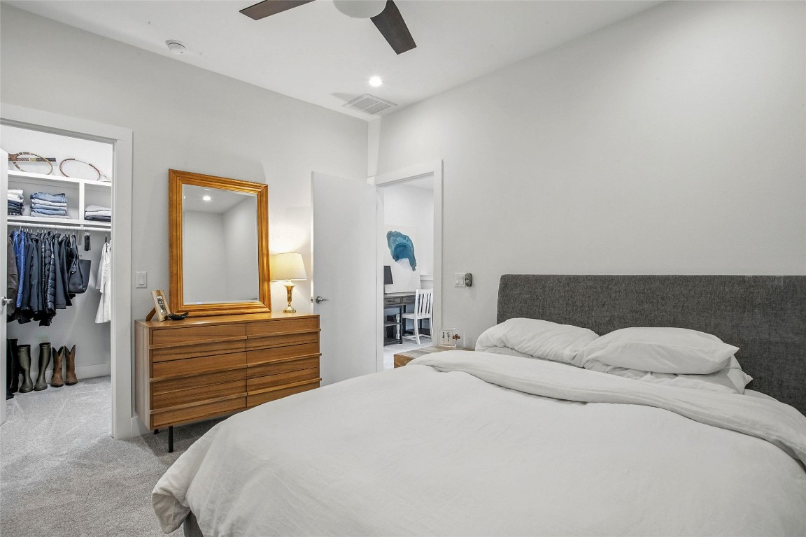 5402 Woodrow Avenue, Unit B Austin, TX 78756 - Photo 29 of 36 a bedroom with a bed and wooden floor