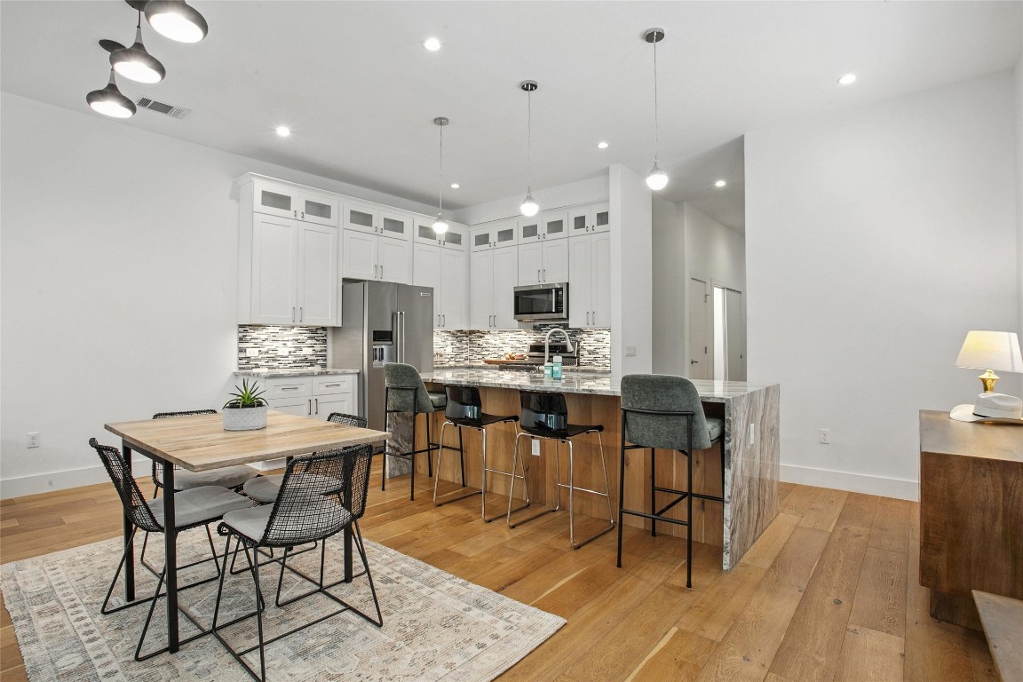 5402 Woodrow Avenue, Unit B Austin, TX 78756 - Photo 5 of 36 a view of a dining room with furniture and wooden floor