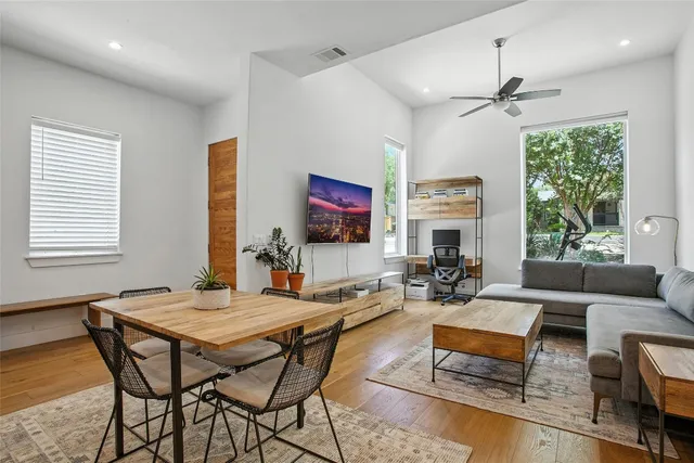 a living room with fireplace furniture and a large window