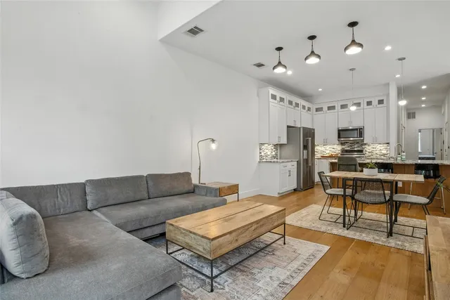 a living room with furniture and kitchen view