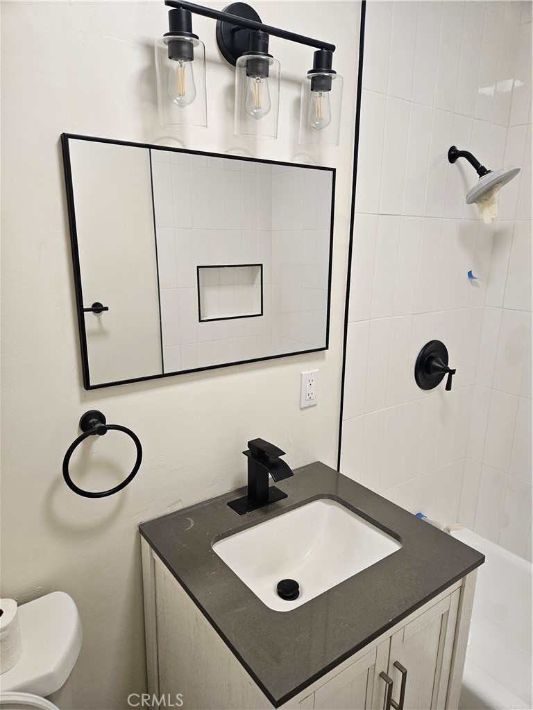 13100 Skiomah Road Apple Valley, CA 92308 - Photo 12 of 19 a bathroom with a sink vanity mirror and toilet