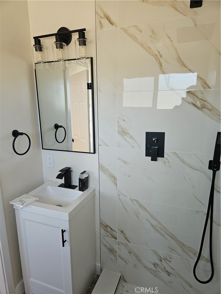 13100 Skiomah Road Apple Valley, CA 92308 - Photo 13 of 19 a bathroom with a shower and a sink