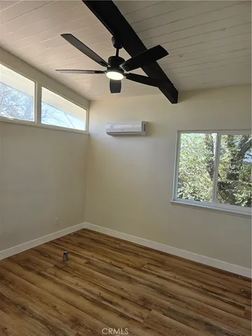 a view of a room with wooden floor cabinets and a window