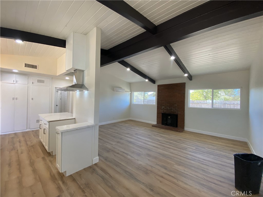13100 Skiomah Road Apple Valley, CA 92308 - Photo 5 of 19 a view of a kitchen with furniture and wooden floor