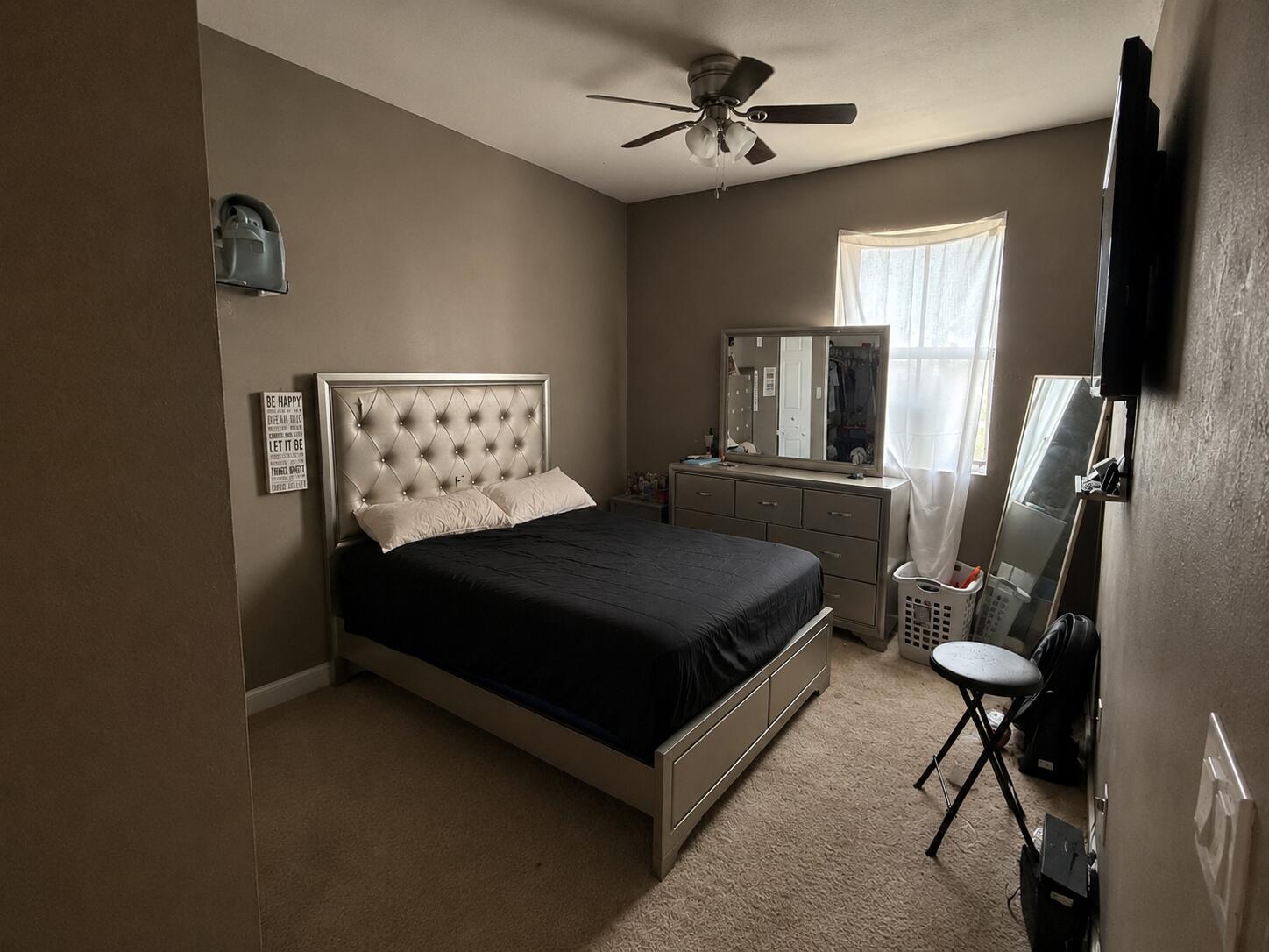 10463 Southwest 228th Terrace Miami, FL 33190 - Photo 5 of 8 a bedroom with a bed a mirror on dresser and a wooden floor