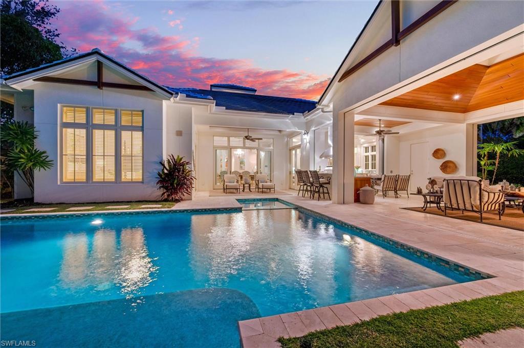 2250 Crayton Road Naples, FL 34103 - Photo 2 of 45 a view of a swimming pool with outdoor seating