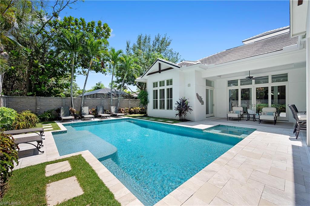 2250 Crayton Road Naples, FL 34103 - Photo 22 of 45 a view of a house with swimming pool and sitting area