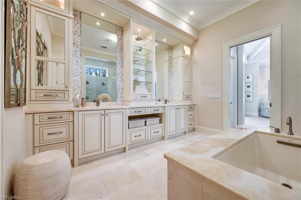 2250 Crayton Road Naples, FL 34103 - Photo 27 of 45 a large bathroom with a granite countertop double vanity sink a mirror and a bathtub