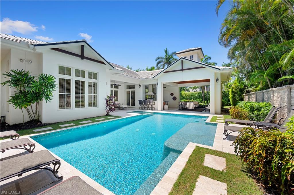 2250 Crayton Road Naples, FL 34103 - Photo 37 of 45 a view of a house with a backyard and a patio