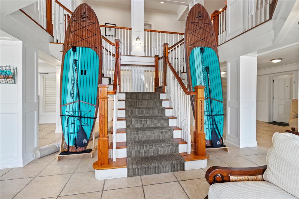 101 66th Street, Unit 6 Holmes Beach, FL 34217 - Photo 14 of 48 a view of staircase with white walls and a fireplace