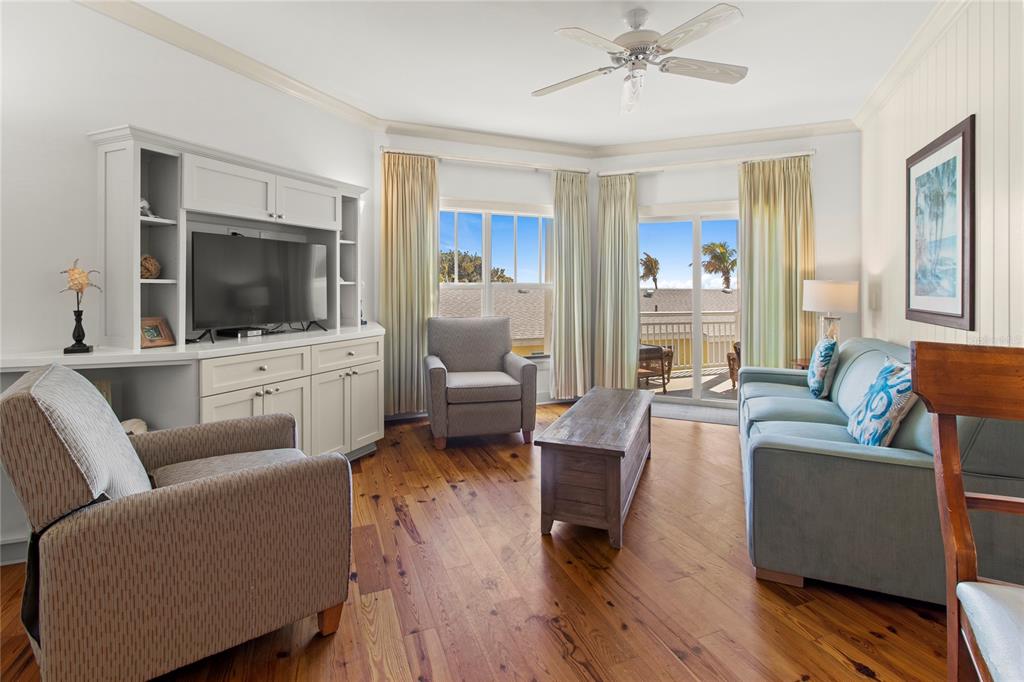101 66th Street, Unit 6 Holmes Beach, FL 34217 - Photo 25 of 48 a living room with furniture and a flat screen tv