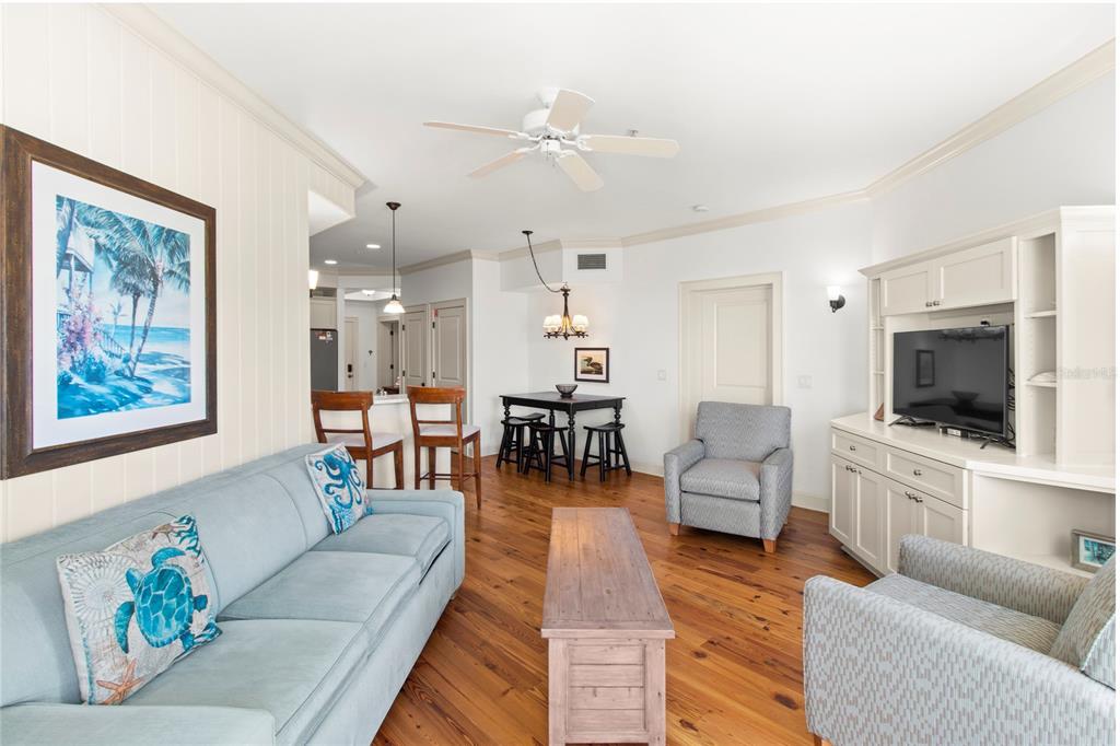 101 66th Street, Unit 6 Holmes Beach, FL 34217 - Photo 27 of 48 a living room with furniture and a flat screen tv