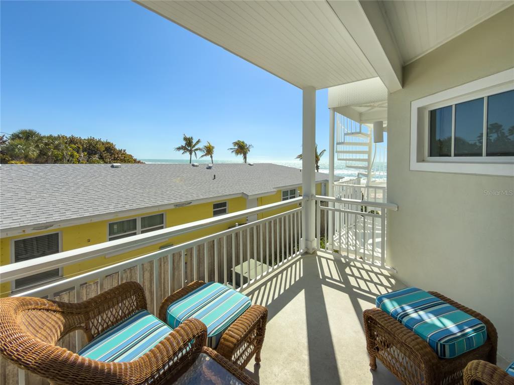 101 66th Street, Unit 6 Holmes Beach, FL 34217 - Photo 28 of 48 a balcony with table and chairs