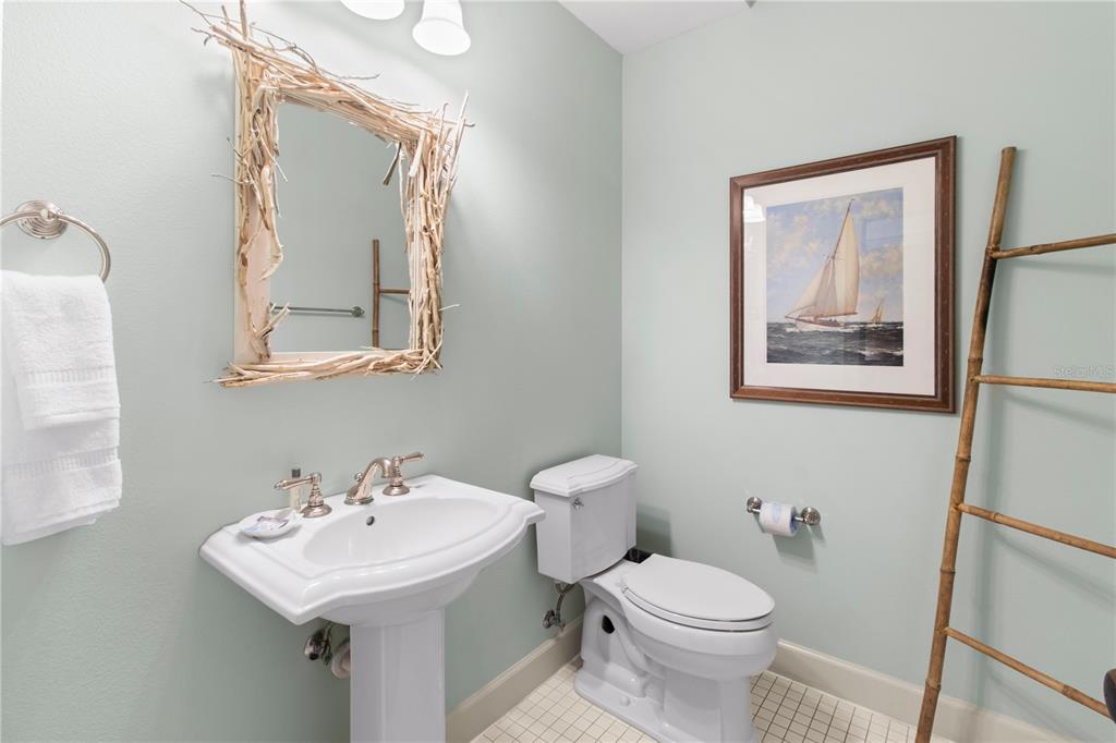 101 66th Street, Unit 6 Holmes Beach, FL 34217 - Photo 30 of 48 a bathroom with a toilet sink and mirror