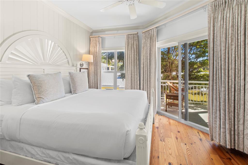 101 66th Street, Unit 6 Holmes Beach, FL 34217 - Photo 32 of 48 a bedroom with a bed and a window