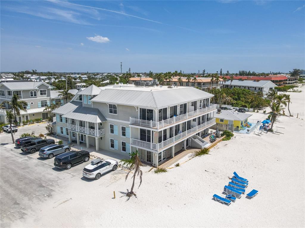 101 66th Street, Unit 6 Holmes Beach, FL 34217 - Photo 4 of 48 an aerial view of a house with a yard