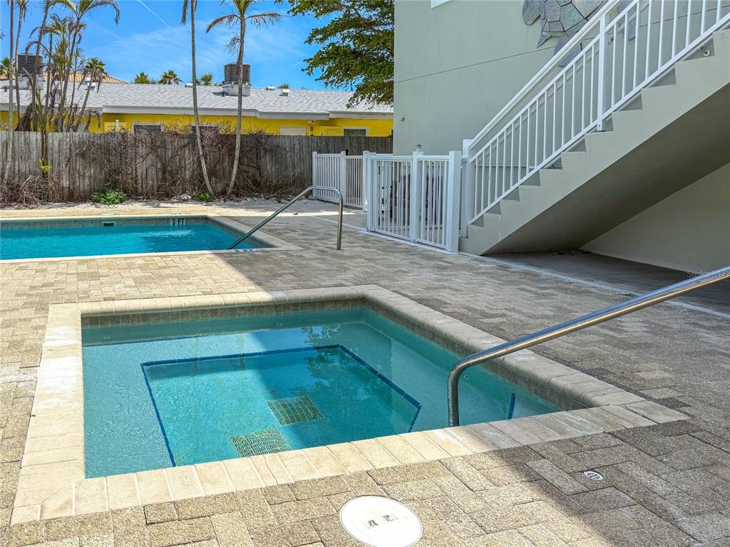 101 66th Street, Unit 6 Holmes Beach, FL 34217 - Photo 45 of 48 a view of a swimming pool with a lounge chairs