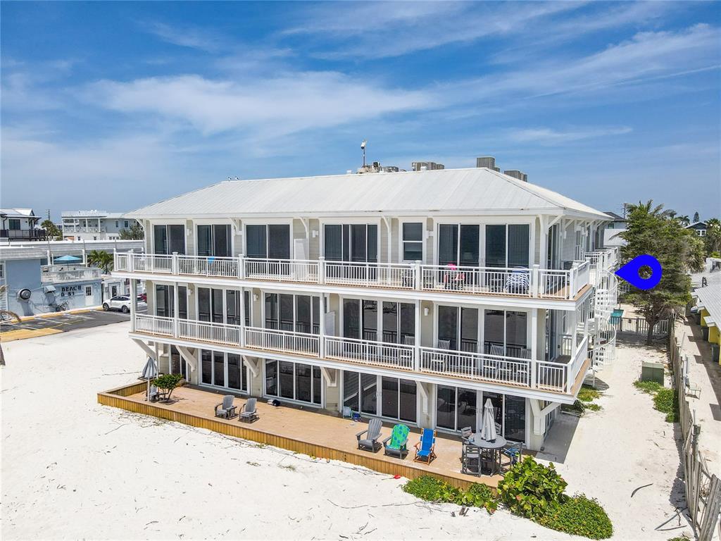 101 66th Street, Unit 6 Holmes Beach, FL 34217 - Photo 5 of 48 a front view of a building with balcony