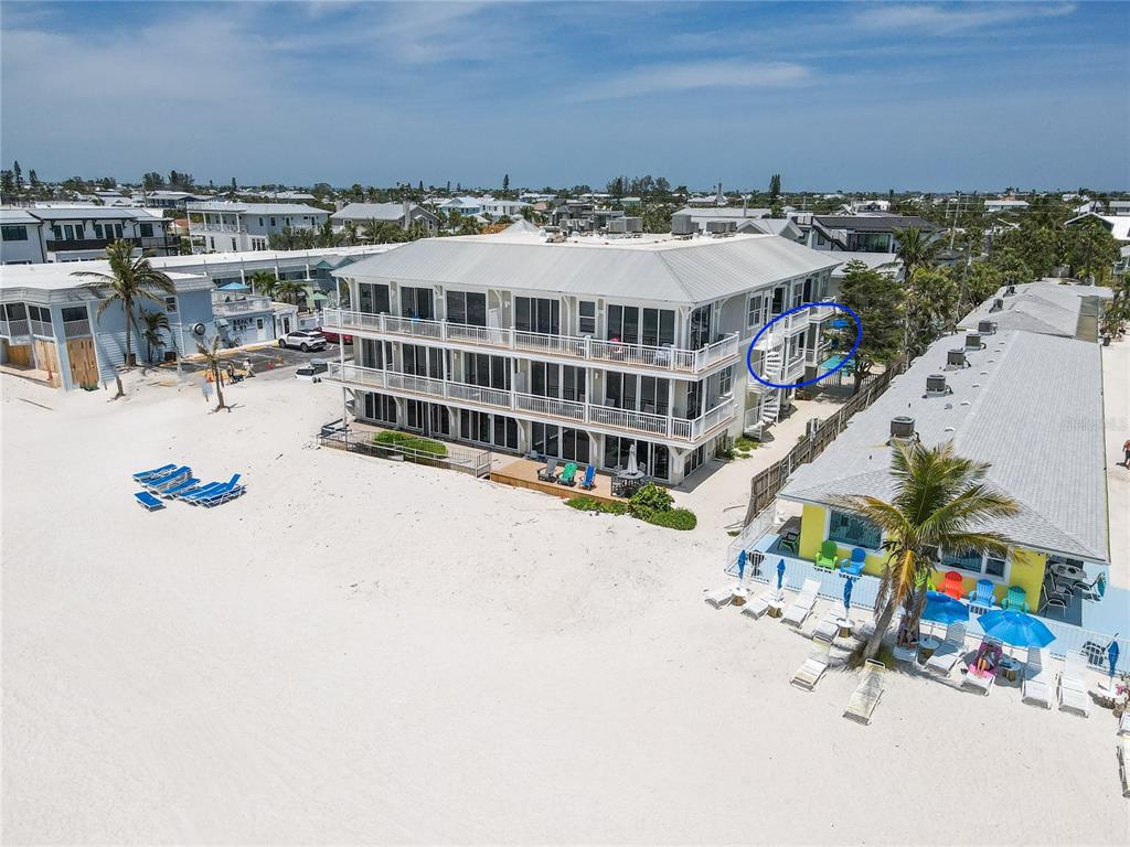 101 66th Street, Unit 6 Holmes Beach, FL 34217 - Photo 6 of 48 a view of a swimming pool with a lounge chairs