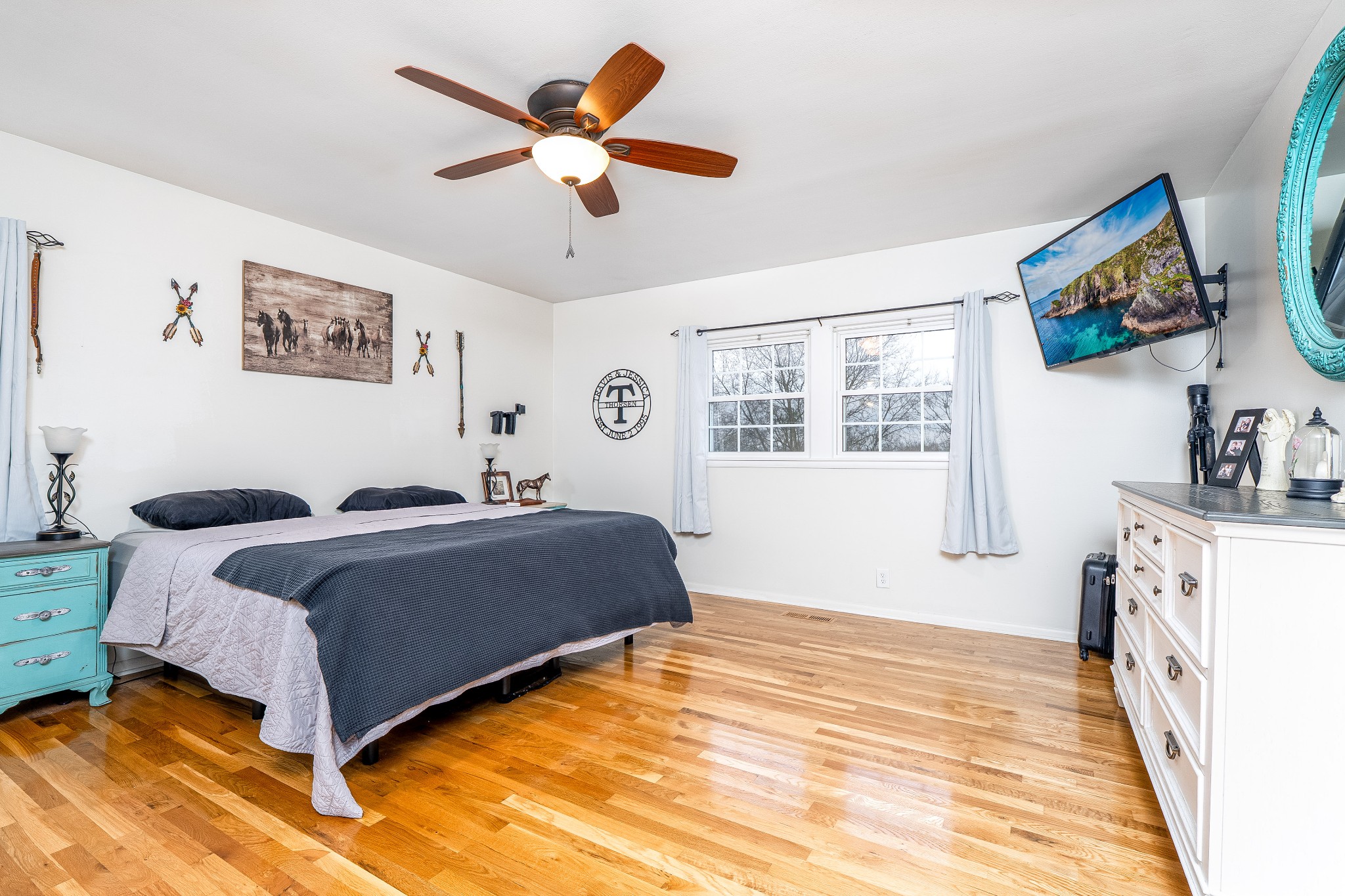 545 Puryears Bend Road Hartsville, TN 37074 - Photo 11 of 46 a spacious bedroom with a large bed a flat screen tv and a window