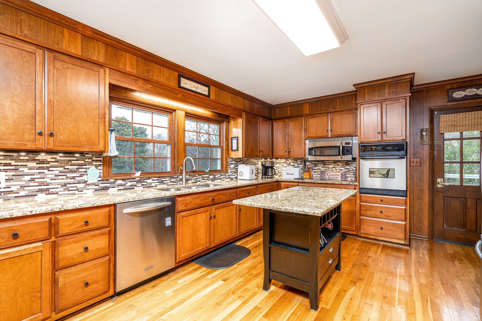 545 Puryears Bend Road Hartsville, TN 37074 - Photo 7 of 46 a kitchen with granite countertop a sink a counter space appliances and cabinets