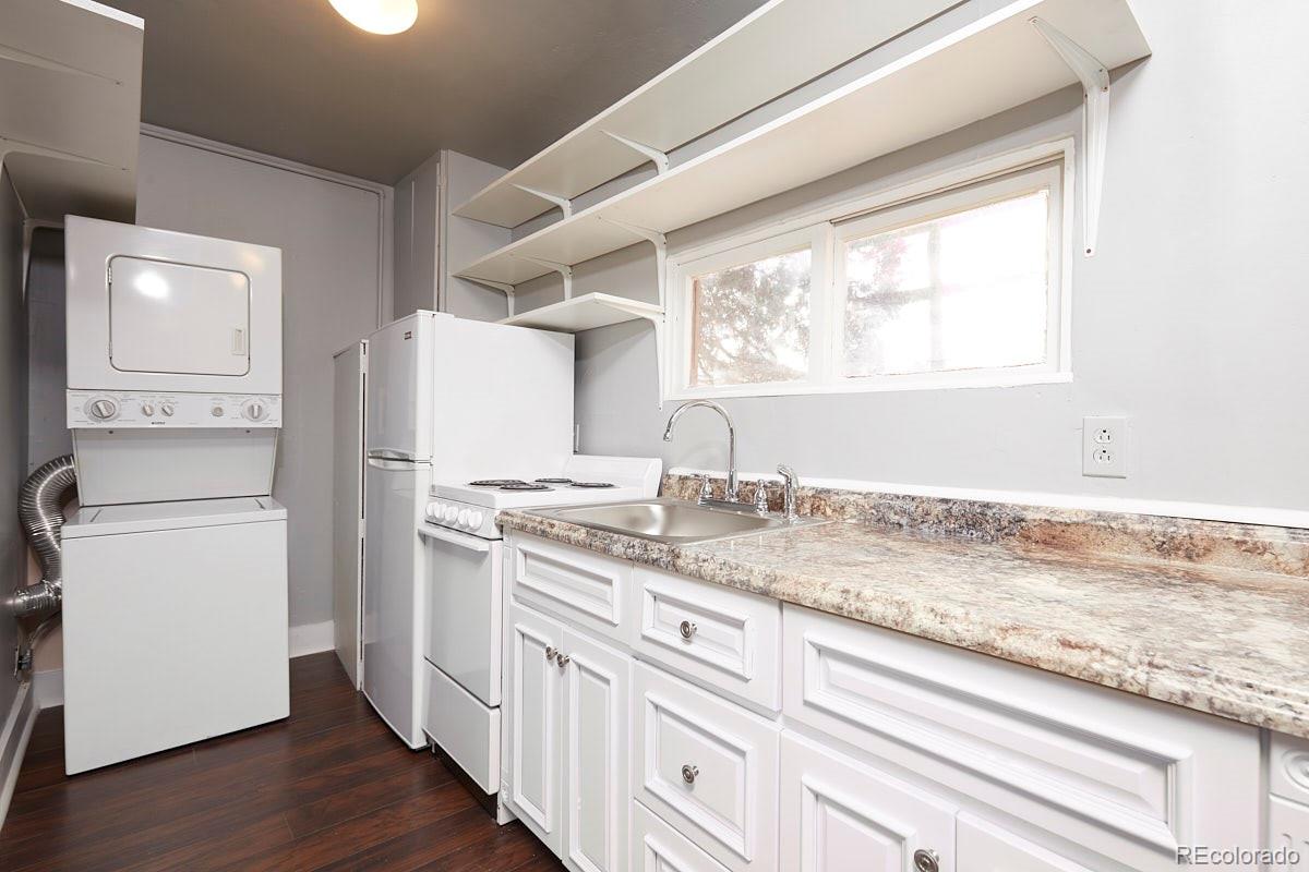 1118 East Platte Avenue, Unit B Colorado Springs, CO 80903 - Photo 6 of 15 a kitchen with granite countertop white cabinets and white appliances