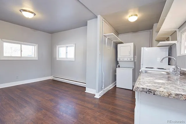 a view of a kitchen with a sink and dishwasher wooden floor
