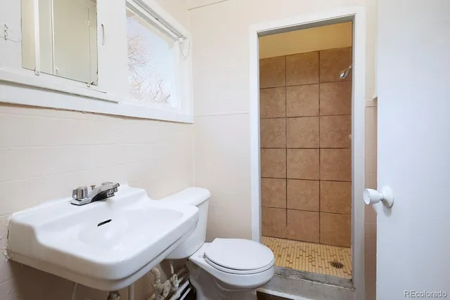 a white toilet sitting next to a bathroom sink