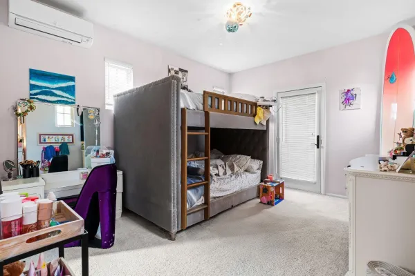 a bedroom with furniture and a flat tv screen