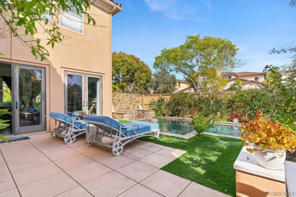 a view of a patio with a table and chairs and potted plants
