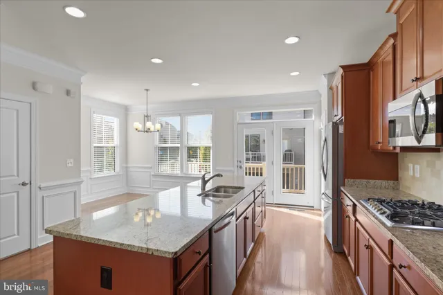 a kitchen with granite countertop a sink stove and cabinets