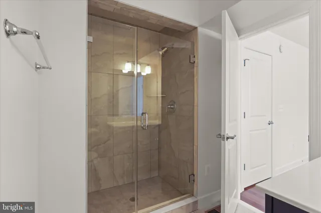 a bathroom with a glass shower door