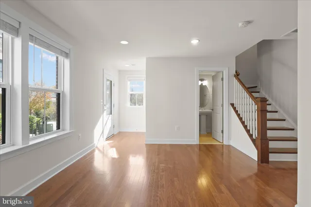 a view of entryway with wooden floor and stairs