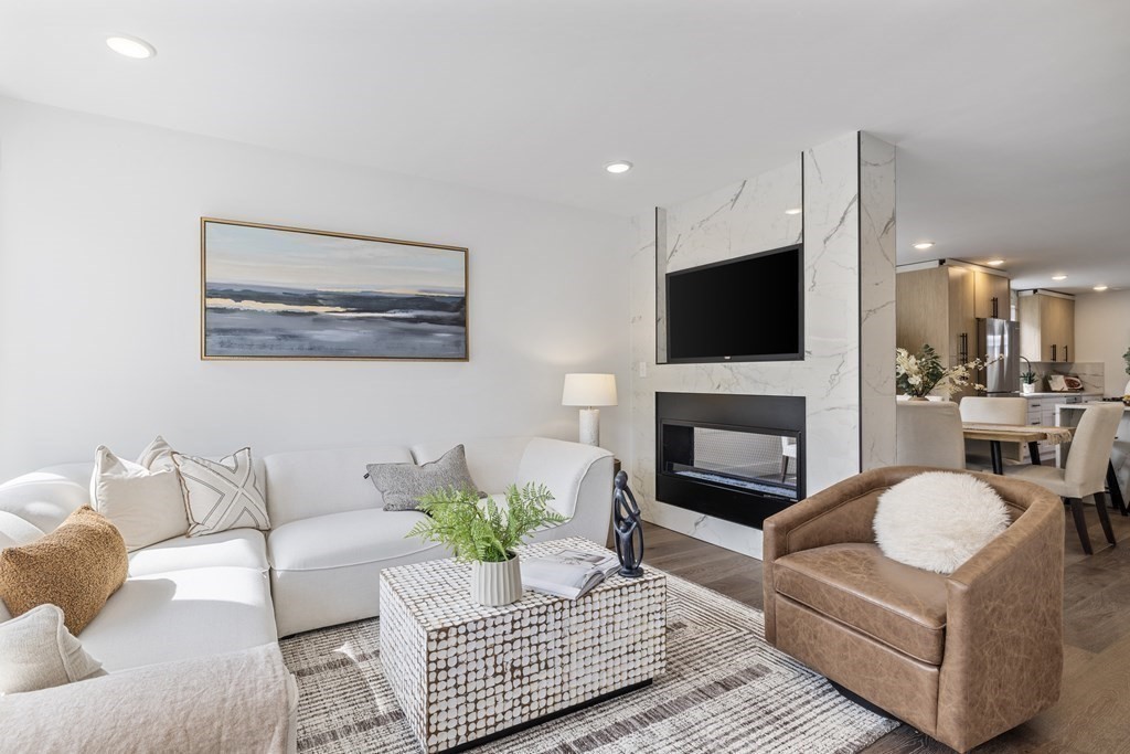 58 Simpson Avenue, Unit 2 Somerville, MA 02144 - Photo 11 of 28 a living room with furniture a flat screen tv and a fireplace