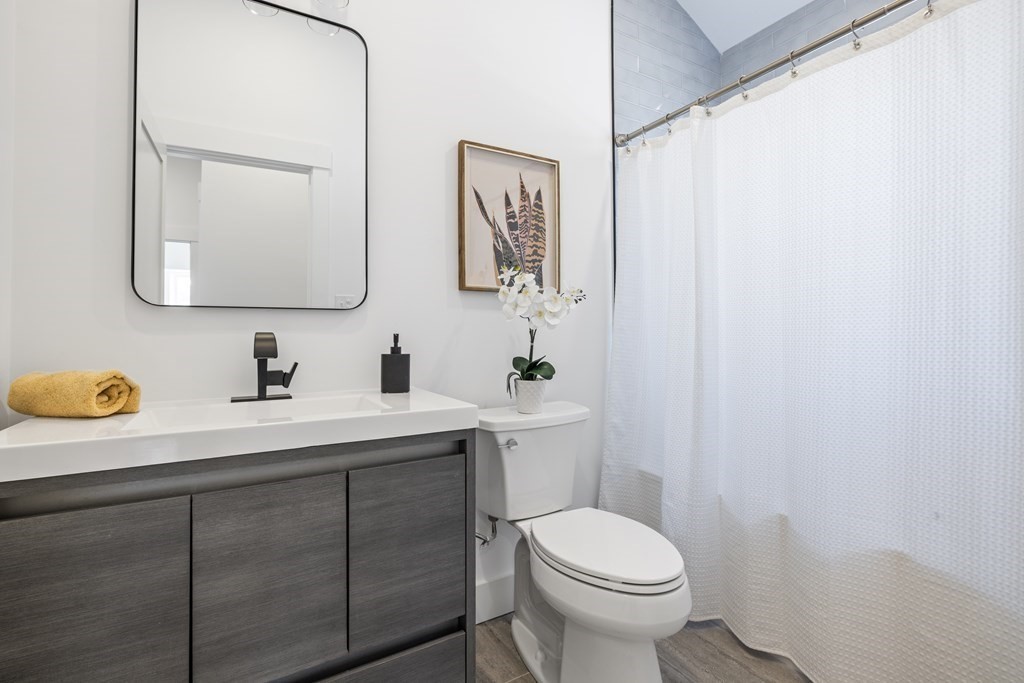 58 Simpson Avenue, Unit 2 Somerville, MA 02144 - Photo 15 of 28 a bathroom with a granite countertop sink mirror and toilet