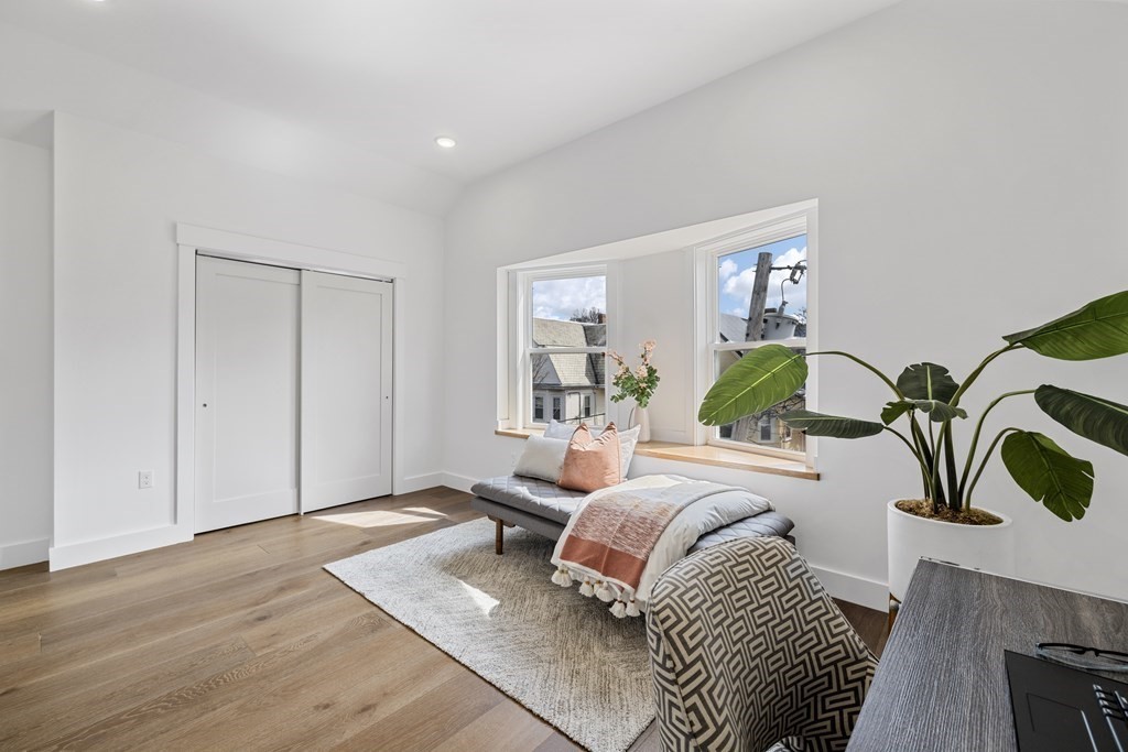 58 Simpson Avenue, Unit 2 Somerville, MA 02144 - Photo 17 of 28 a bedroom with a bed and painting on the wall