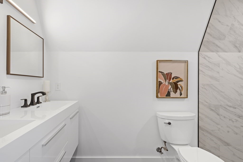 58 Simpson Avenue, Unit 2 Somerville, MA 02144 - Photo 20 of 28 a bathroom with a sink mirror and toilet