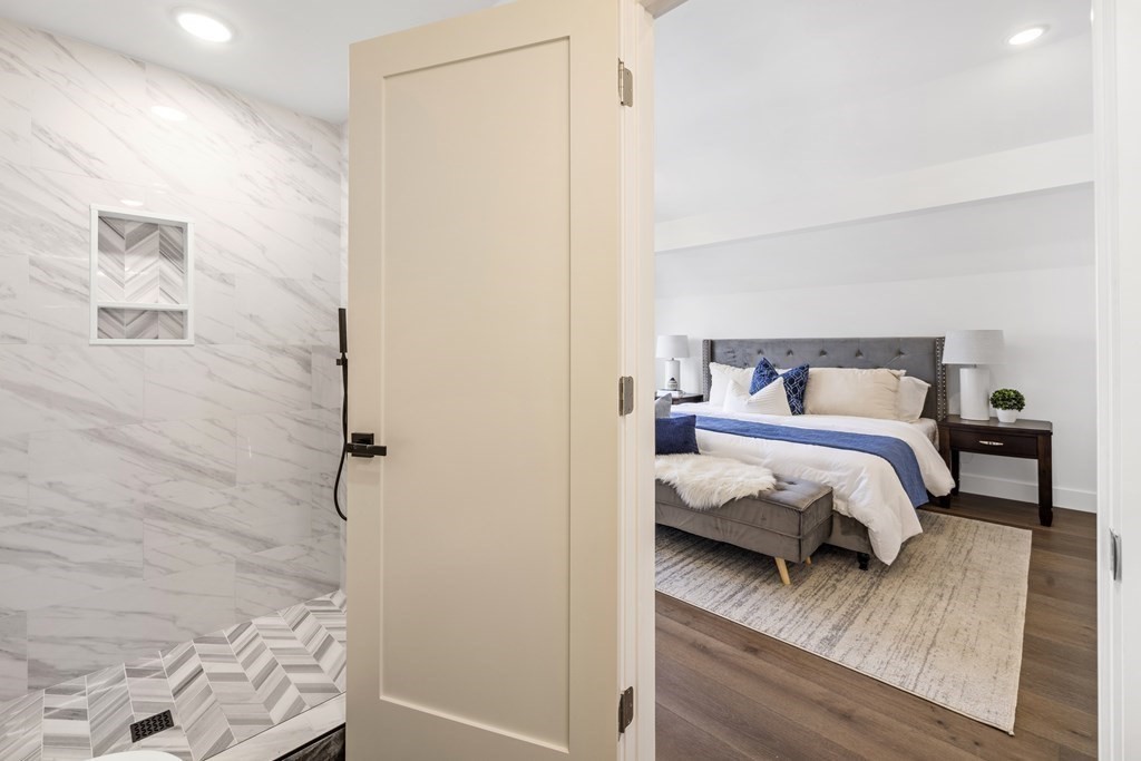 58 Simpson Avenue, Unit 2 Somerville, MA 02144 - Photo 21 of 28 a bedroom with a bed and a mirror